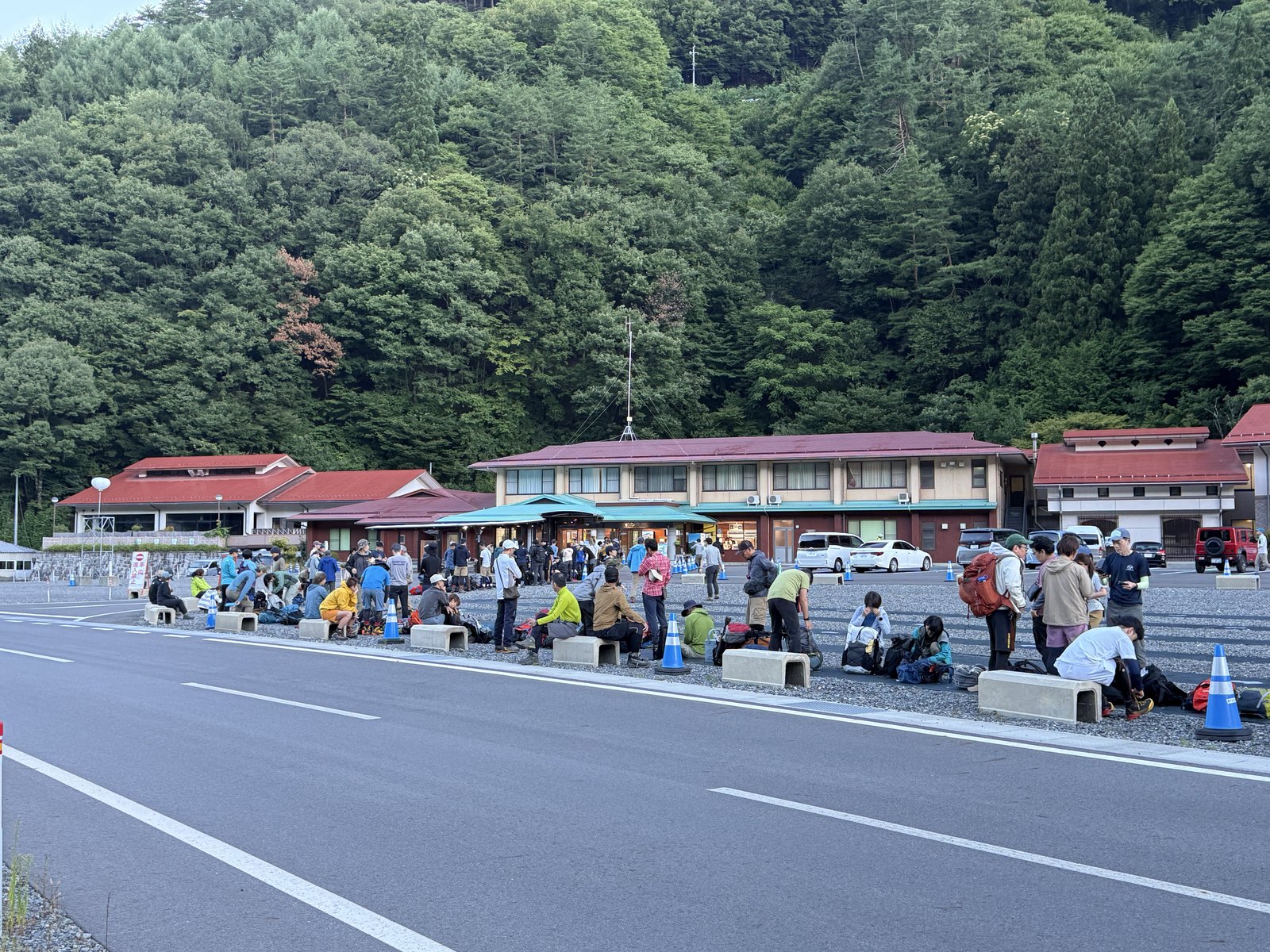夜明けの戸台パーク。コンクリブロックに腰かけて始発バスを待つ登山者