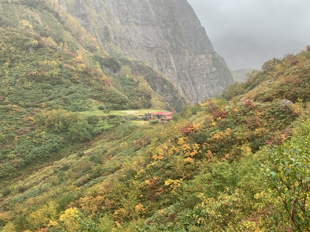 谷あいの紅葉の先に見えてきた池ノ平小屋